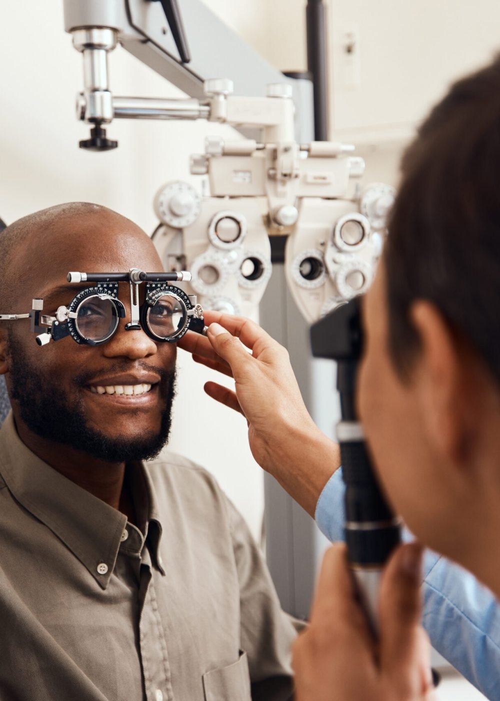 Shot of an young man getting new glasses fitted by an optometrist.